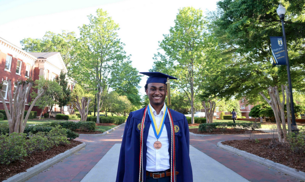 Daniel Araya in UNCG graduation regalia